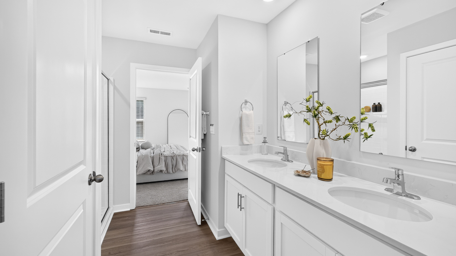 Primary bathroom with standing glass shower and double sinks