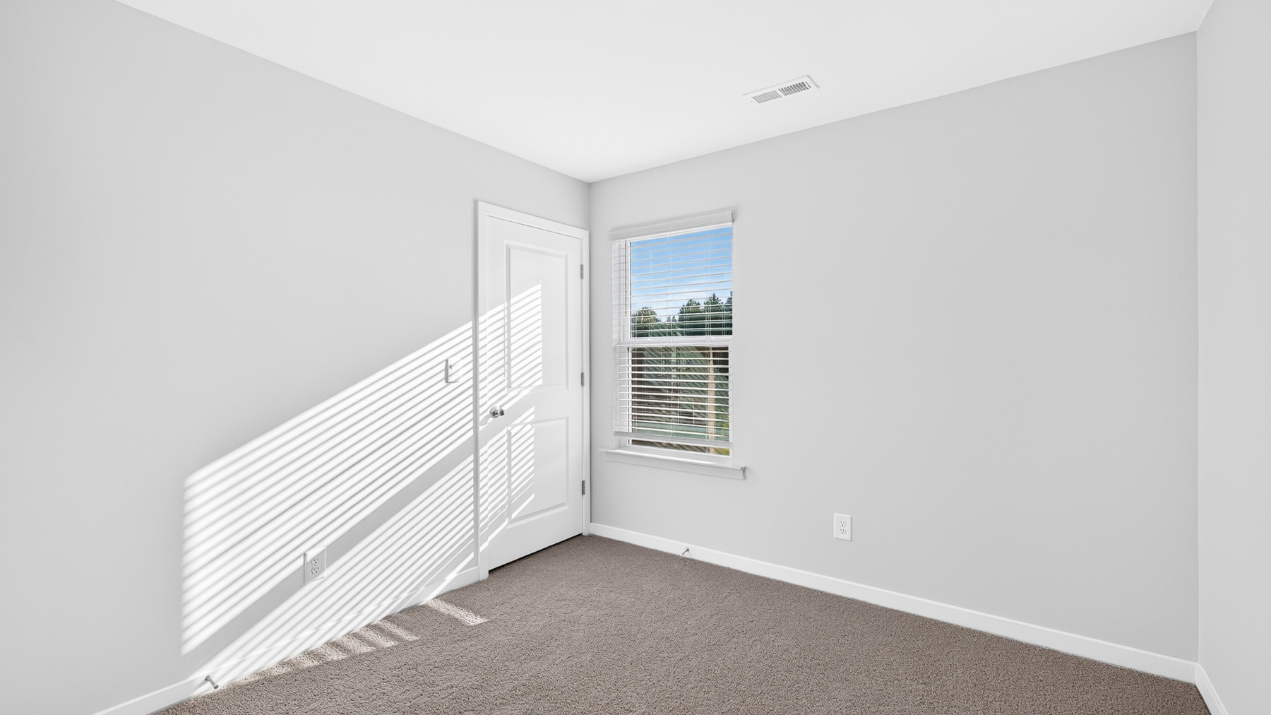 Carpeted bedroom with window