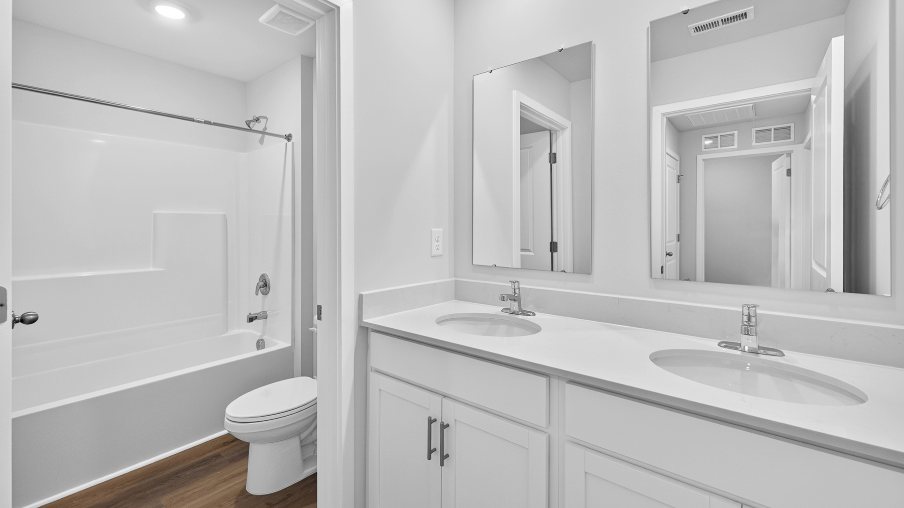 Bathroom with double sinks and tub shower