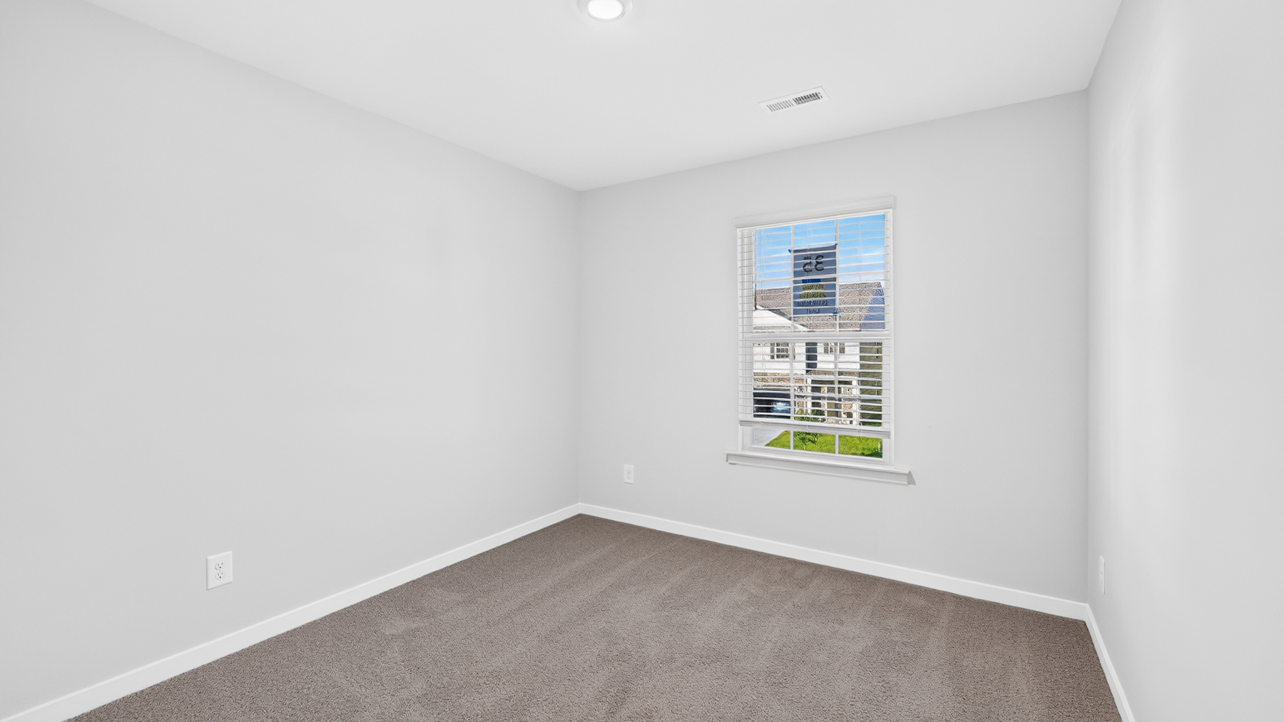 Carpeted bedroom with window
