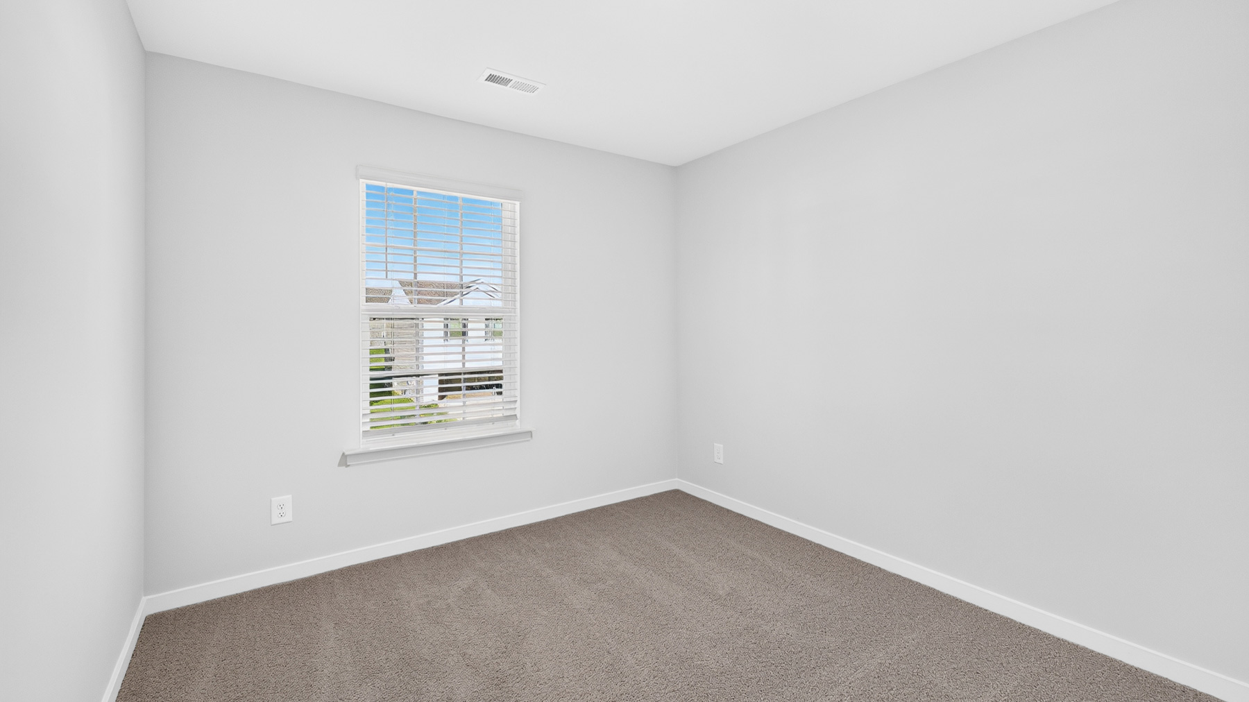 Carpeted bedroom with window