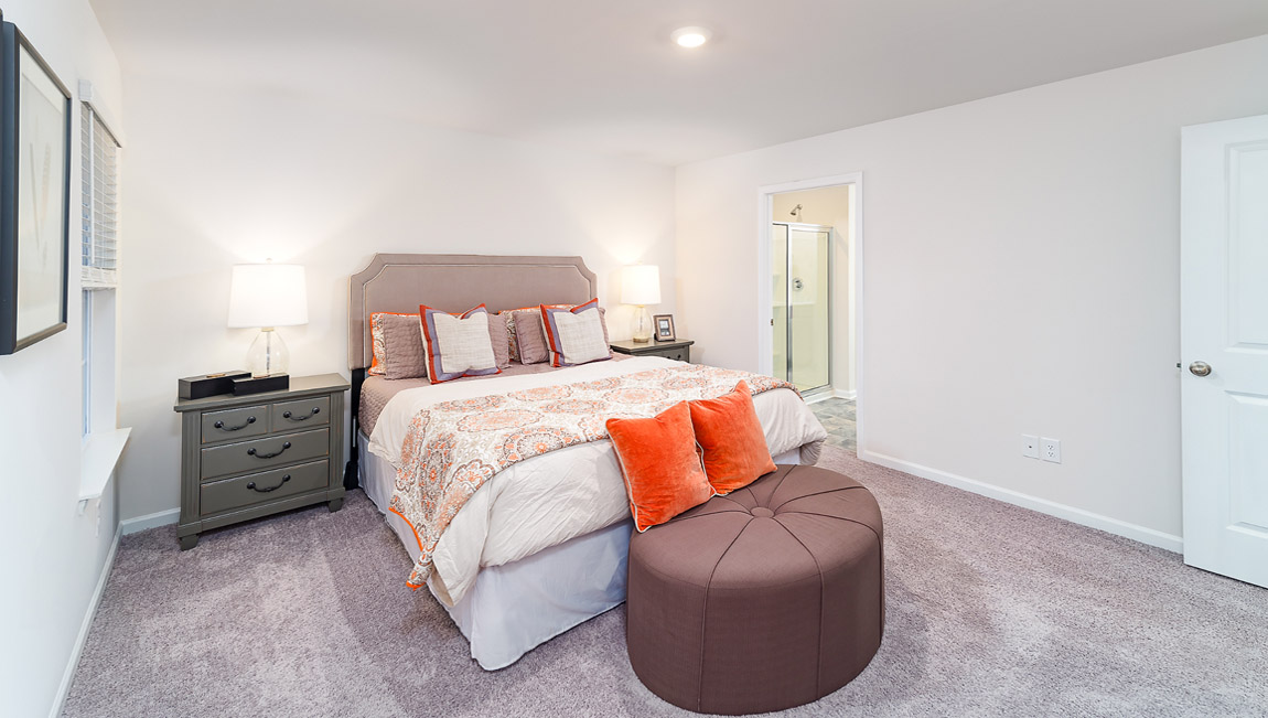 Carpeted bedroom with small windows