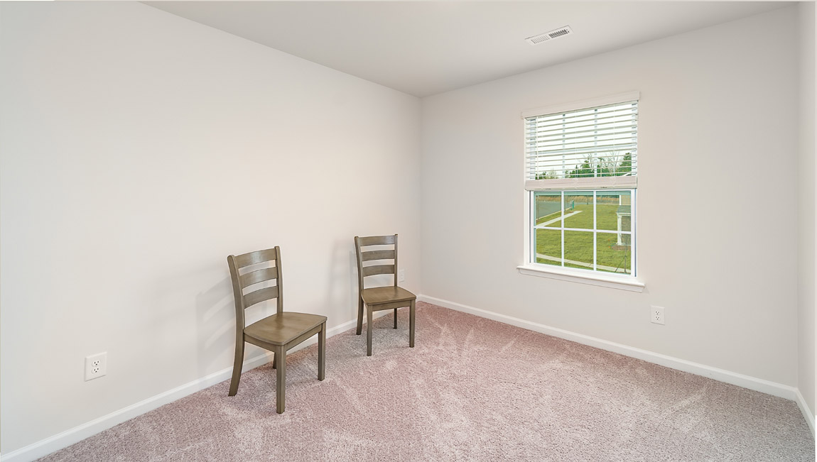 Carpeted bedroom with small window