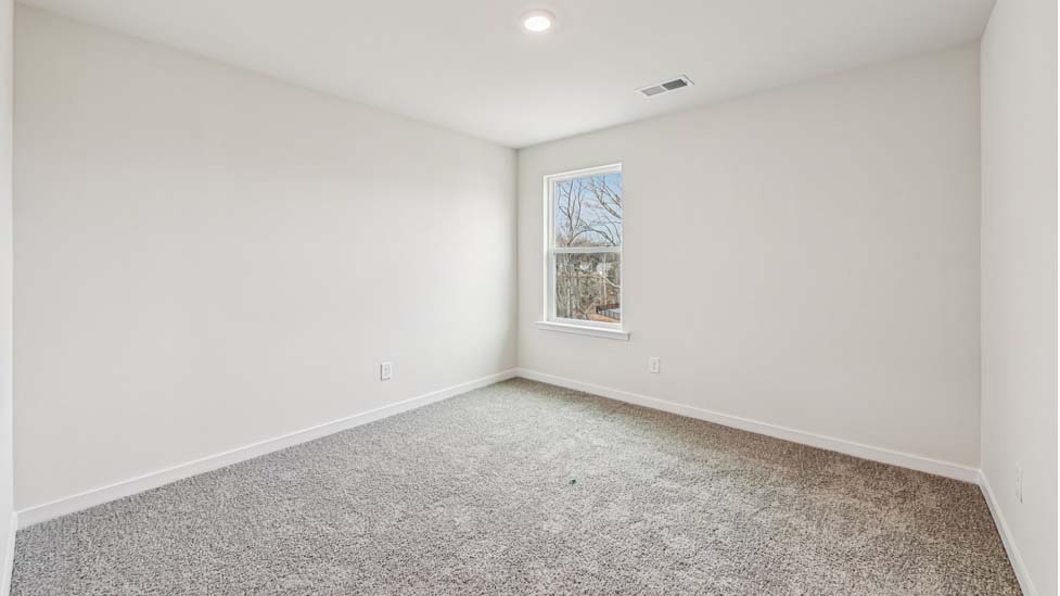 Carpeted bedroom with large window