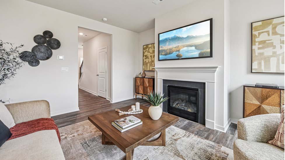 Living room space with wood floors, three large windows