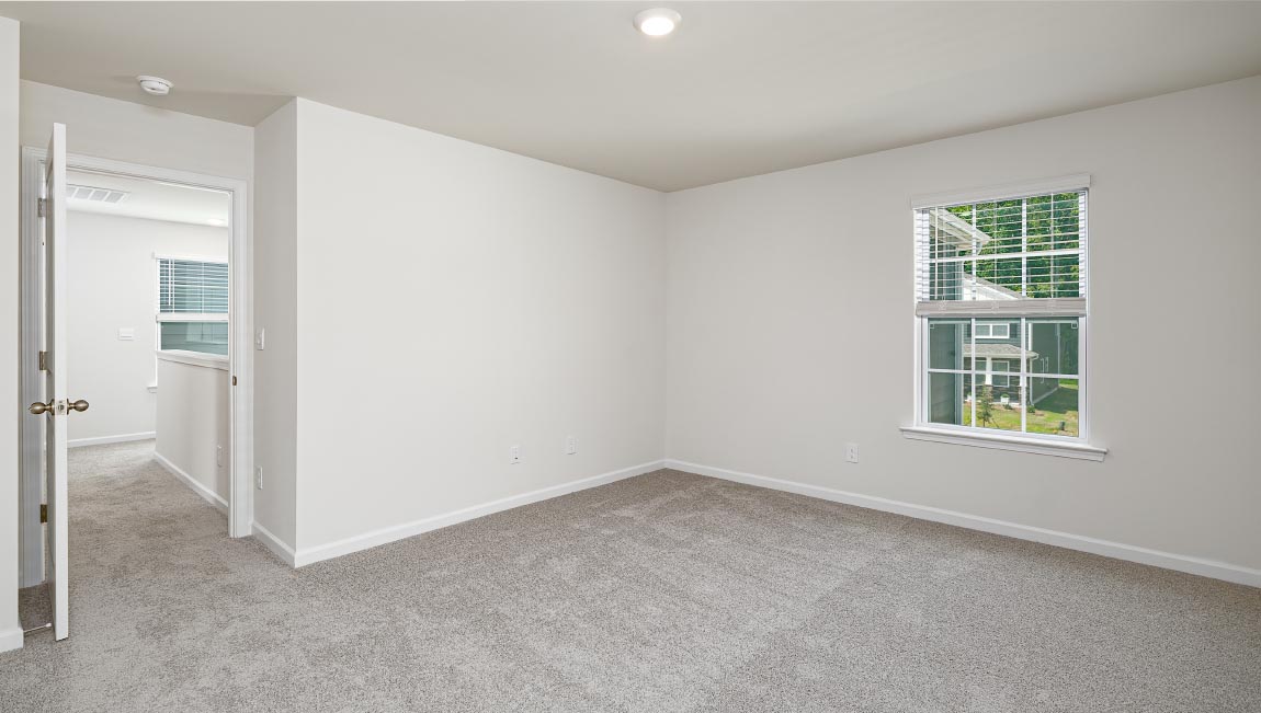 Primary bedroom, carpeted with large windows