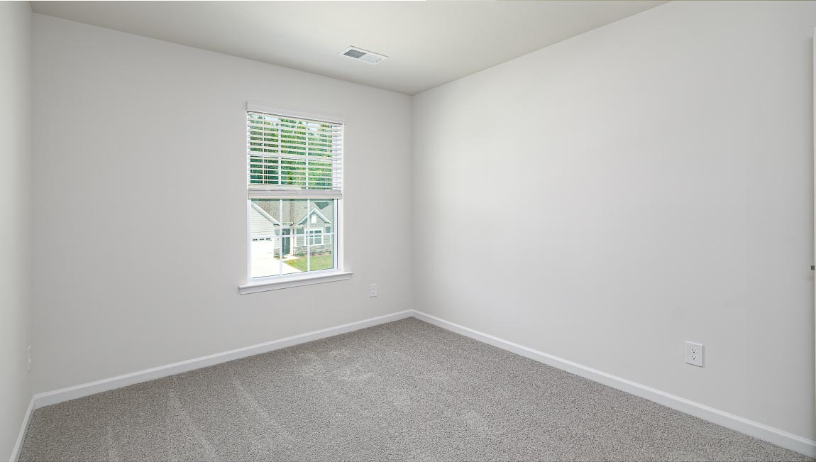 Carpeted bedroom with window
