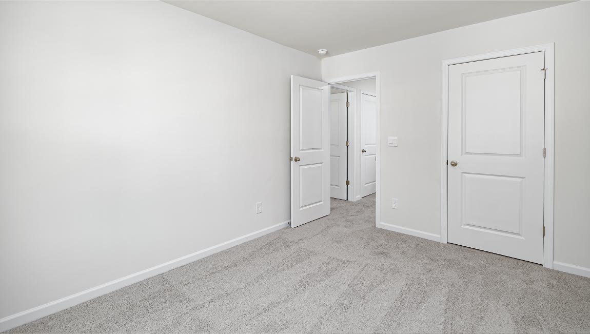 Carpeted bedroom with window