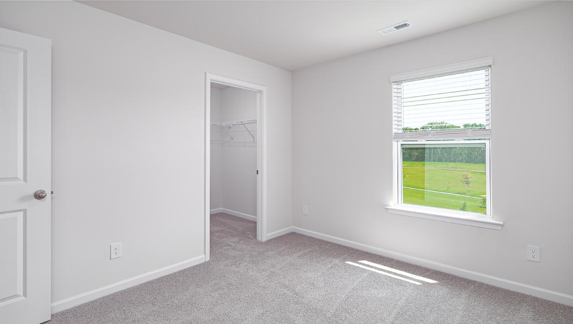 Carpeted bedroom with window