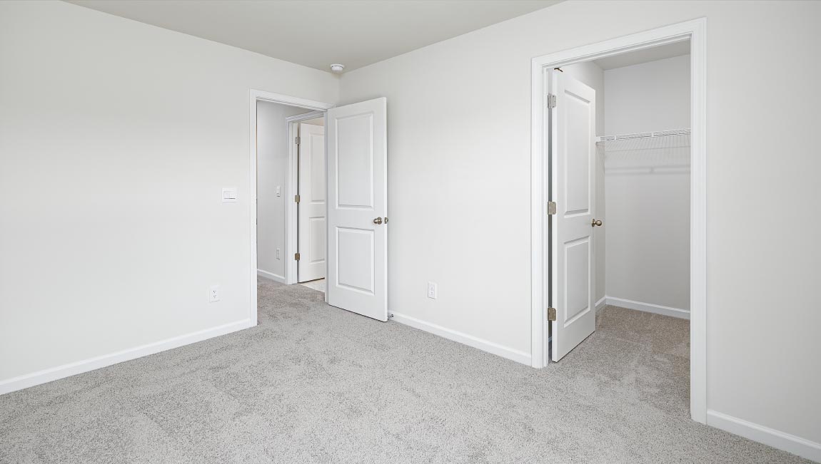 Carpeted bedroom with window