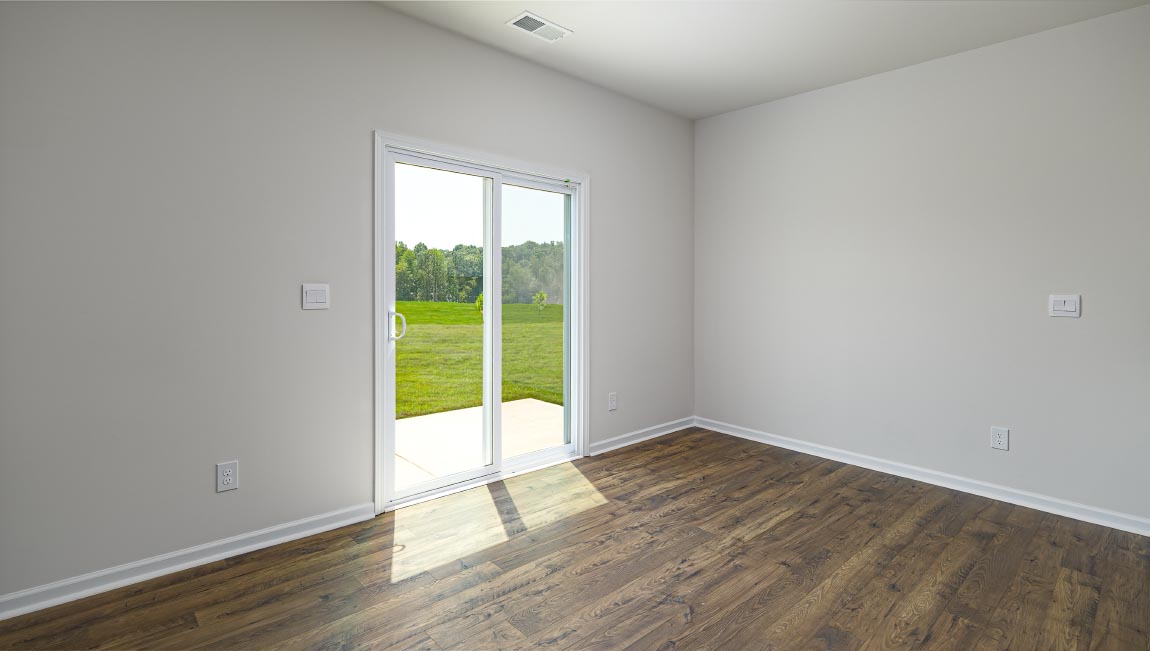 Open dining area near kitchen, with sliding glass doors