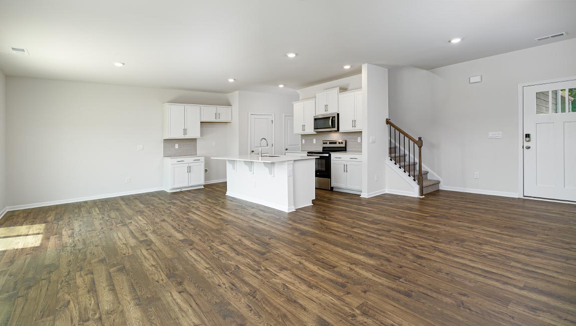 Spacious family room with large windows and fireplace