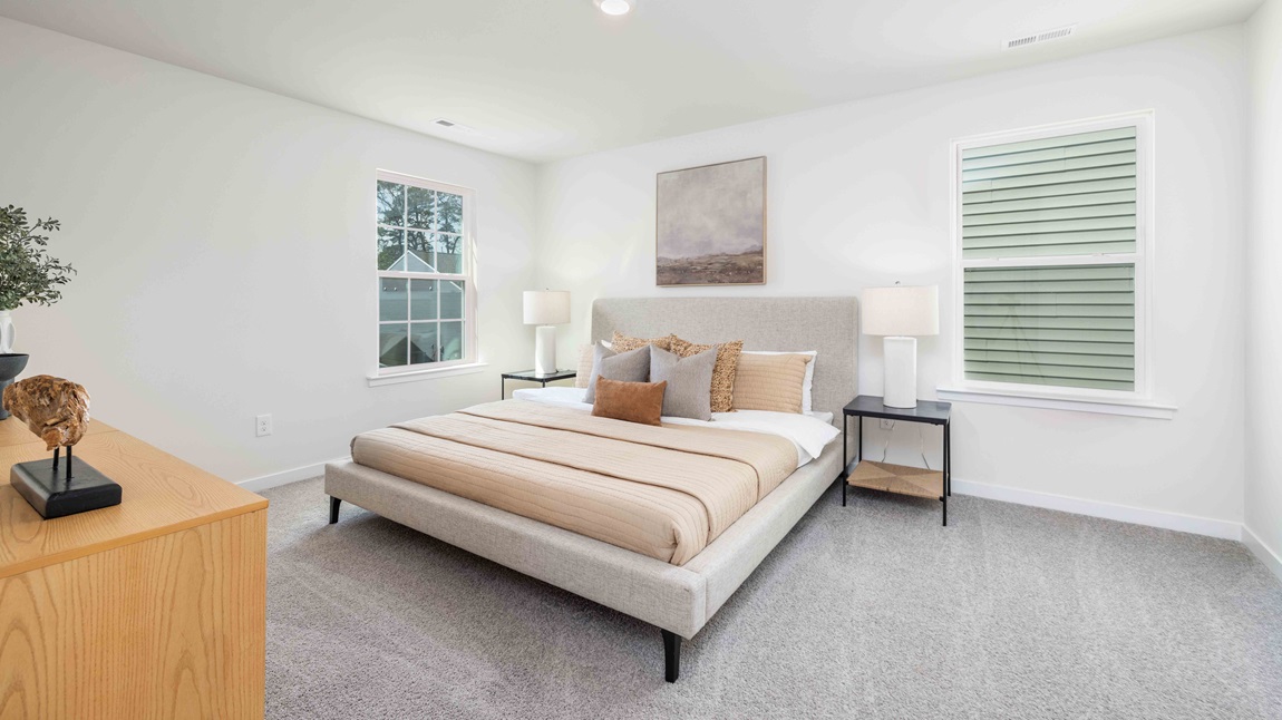 Primary bedroom, carpeted with large windows