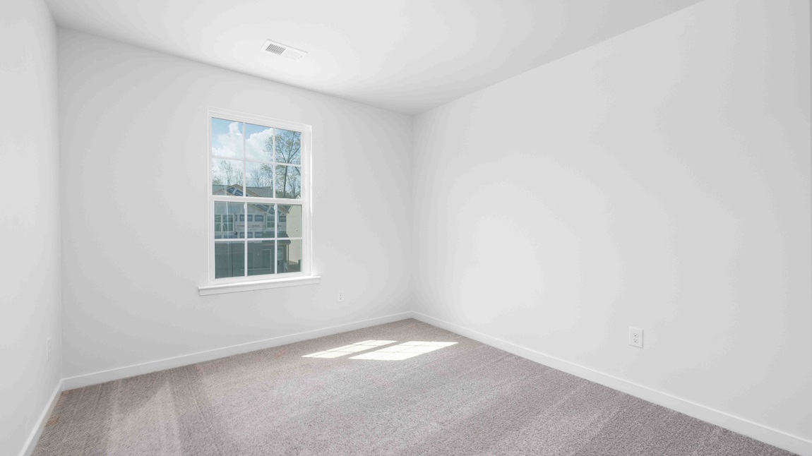 Carpeted bedroom with window