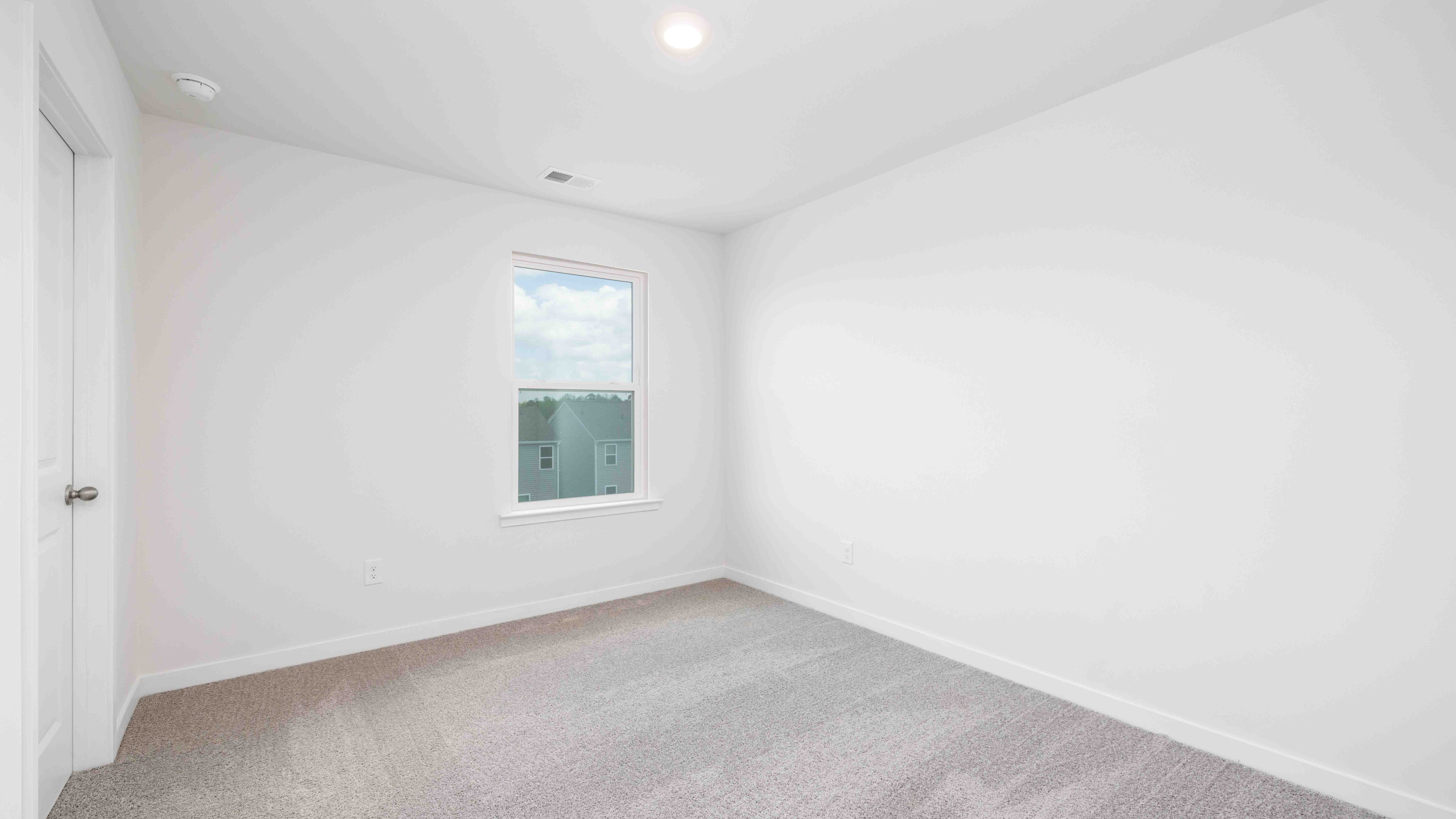 Carpeted bedroom with window