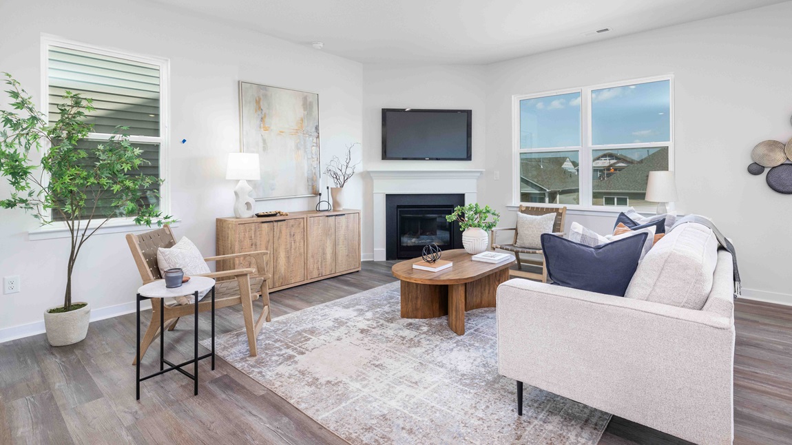 Spacious family room with large windows and fireplace