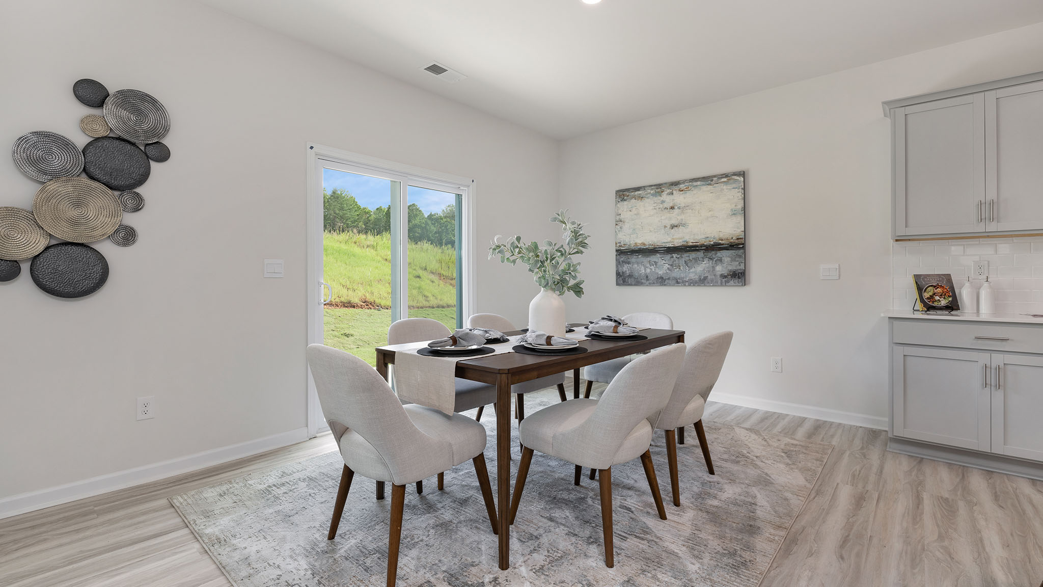Open dining area near kitchen, with sliding glass doors