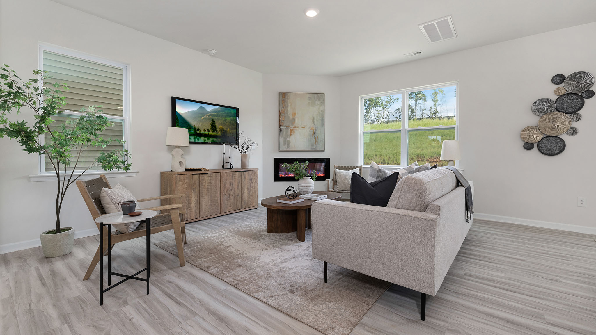 Spacious family room with large windows and fireplace