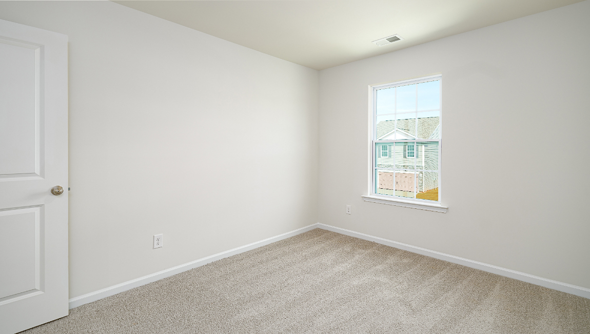 Carpeted bedroom with window