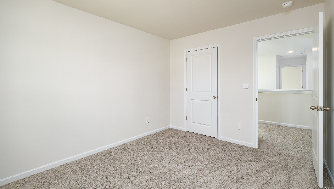 Carpeted bedroom with window