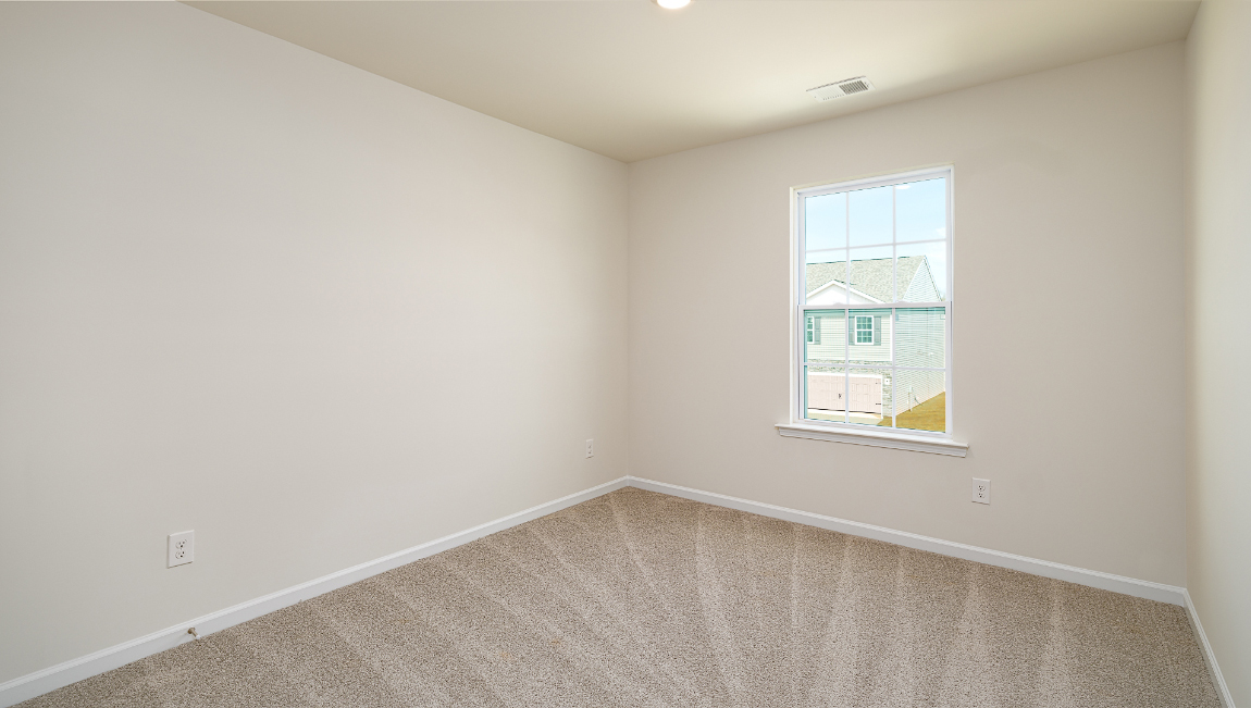Carpeted bedroom with window