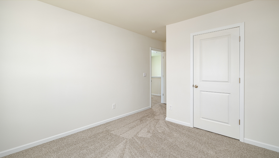 Carpeted bedroom with window