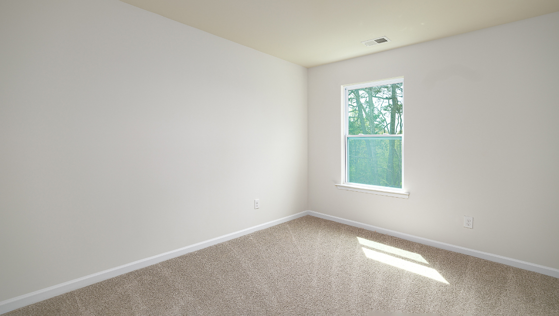 Carpeted bedroom with window