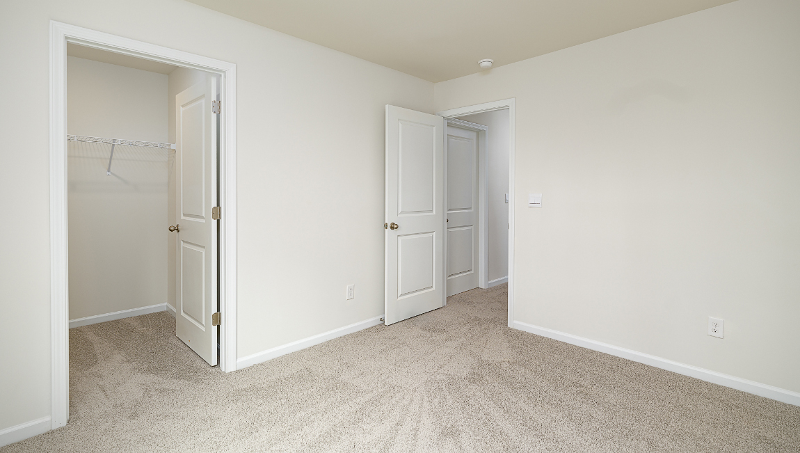 Carpeted bedroom with window