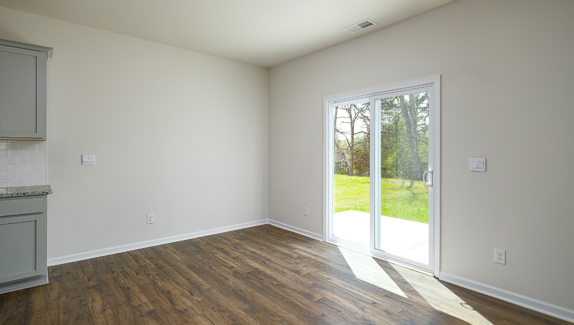 Open dining area near kitchen, with sliding glass doors