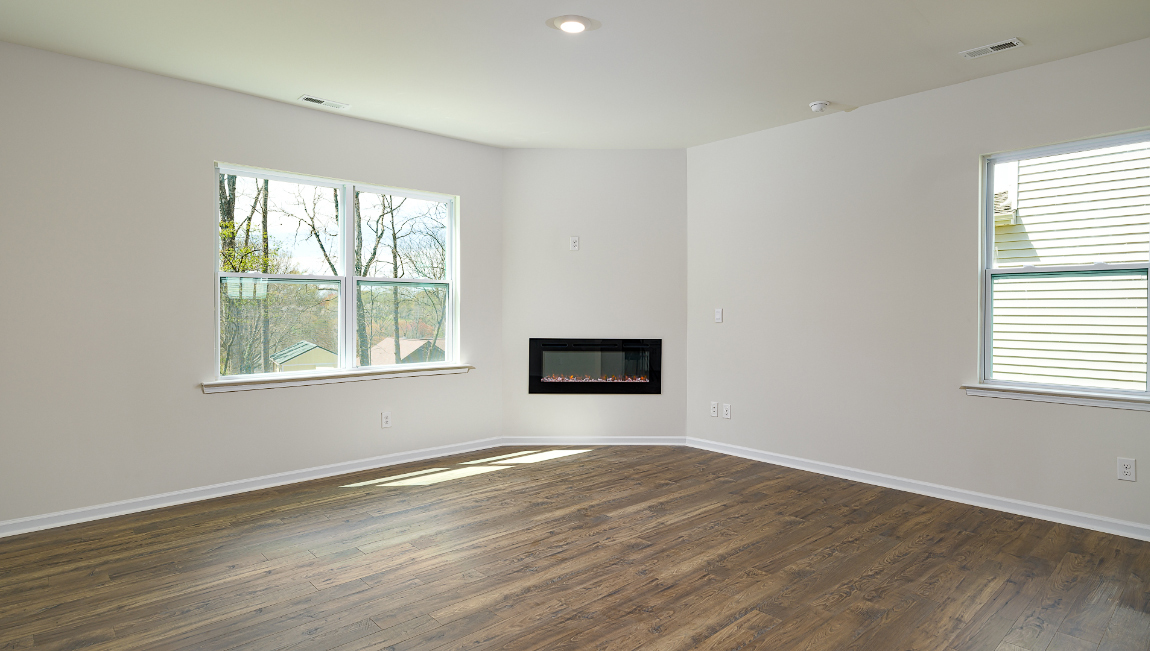 Spacious family room with large windows and fireplace