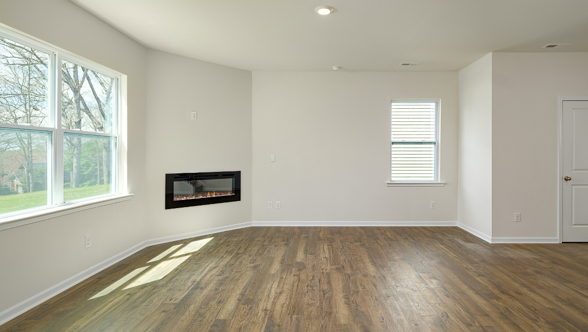 Spacious family room with large windows and fireplace