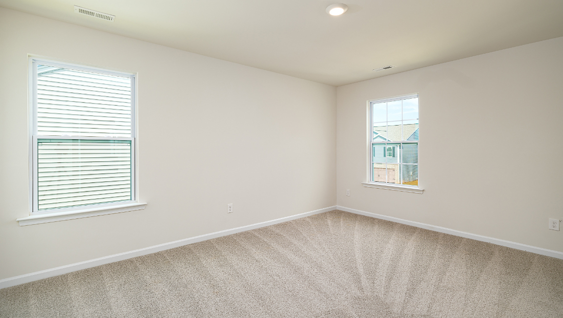 Primary bedroom, carpeted with large windows
