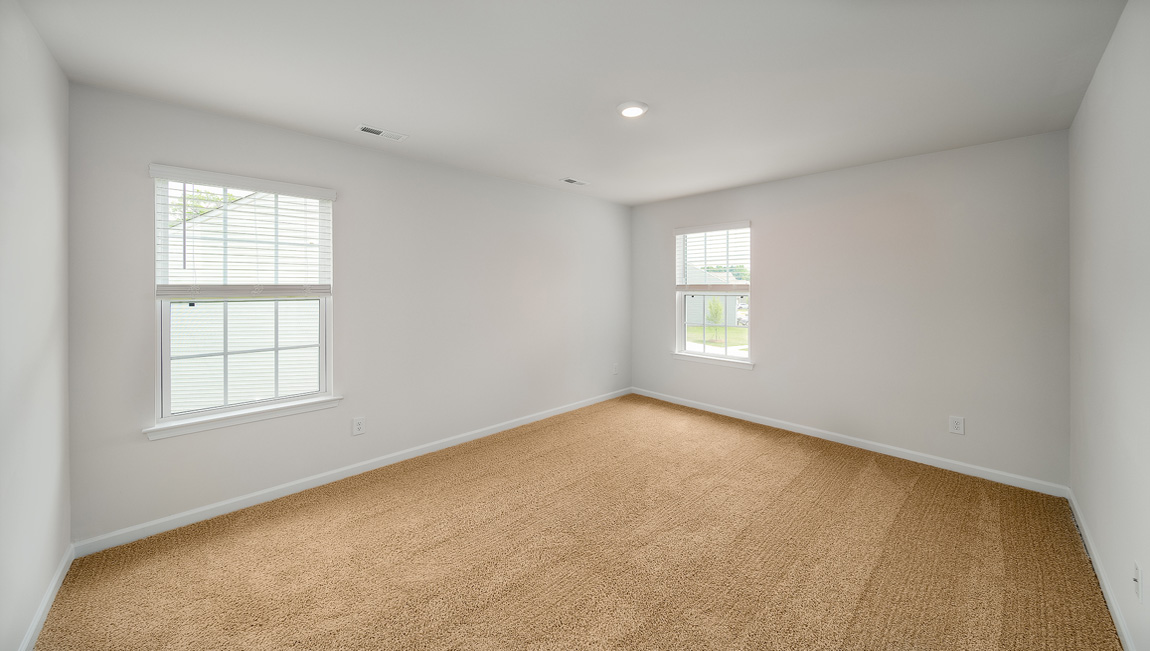 Primary bedroom, carpeted with large windows
