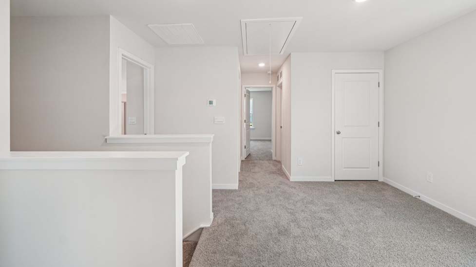 Carpeted loft space atop stairs