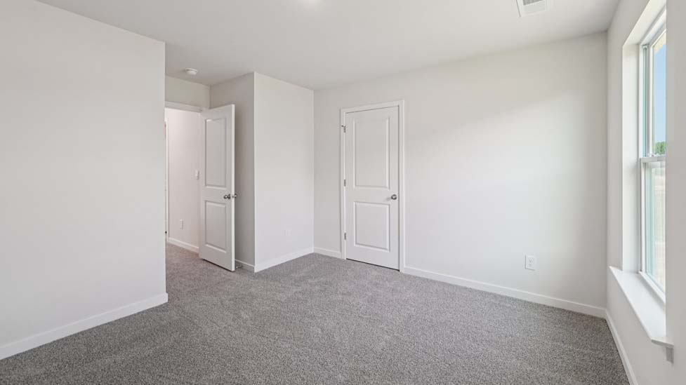 Carpeted bedroom with window
