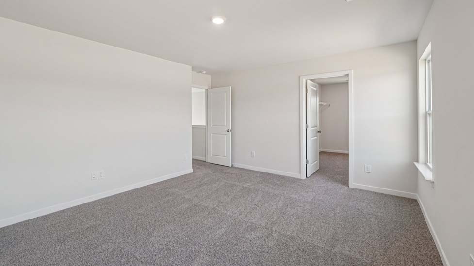 Carpeted bedroom with window
