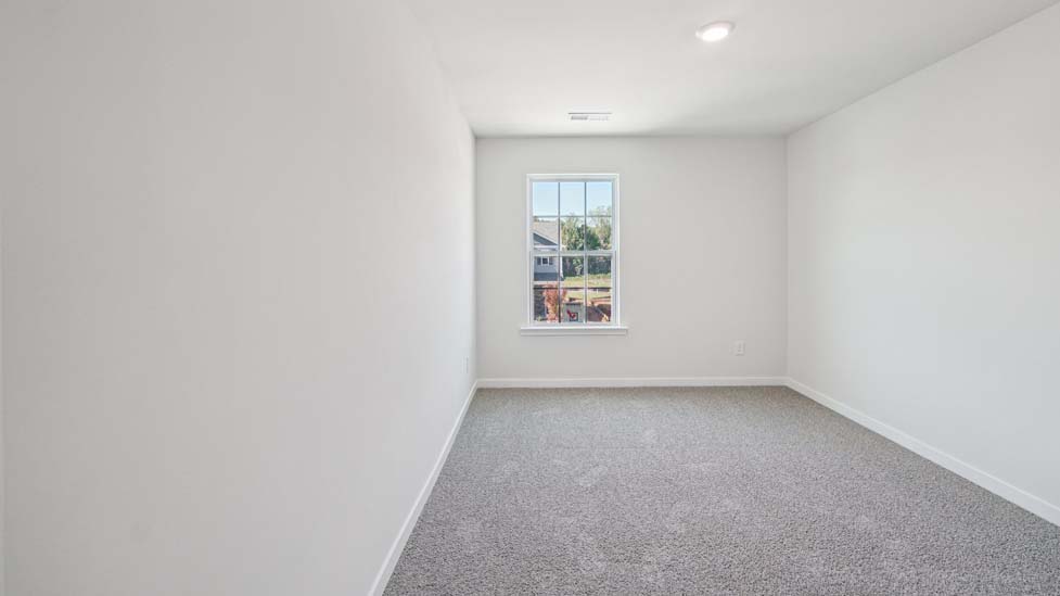 Carpeted bedroom with window