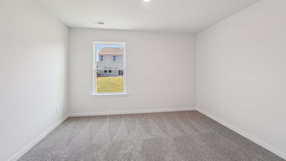 Carpeted bedroom with window