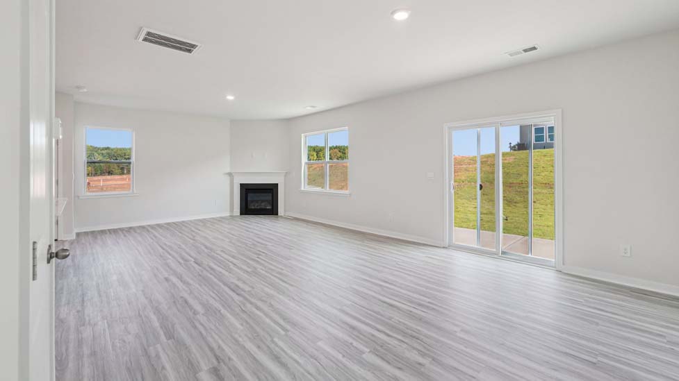 Spacious family room with windows and fireplace