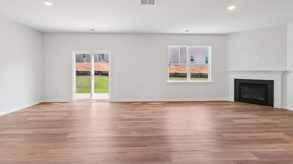 Spacious family room with windows and fireplace