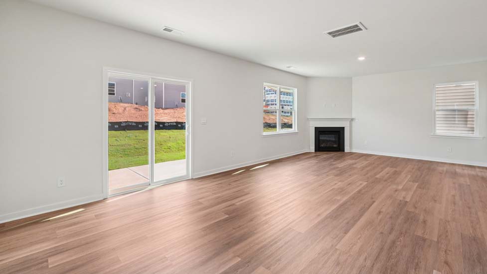 Spacious family room with windows and fireplace