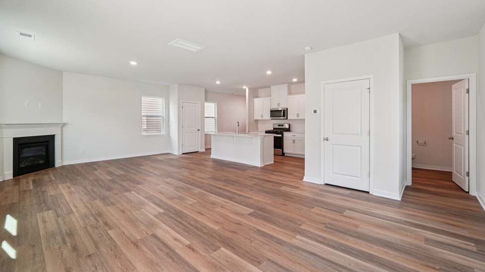 Spacious family room with windows and fireplace