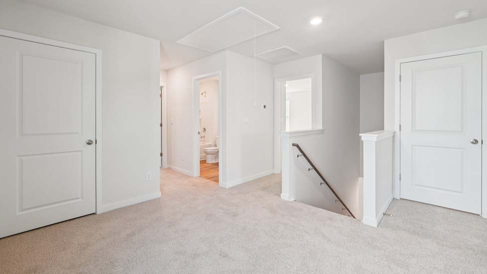 Carpeted loft space atop stairs