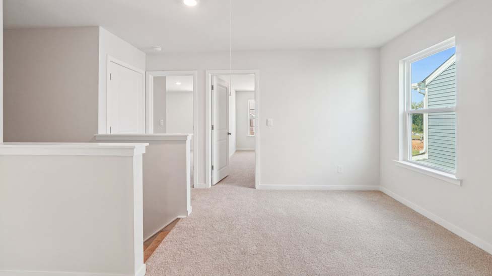 Carpeted loft space atop stairs