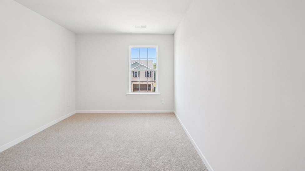 Carpeted bedroom with window