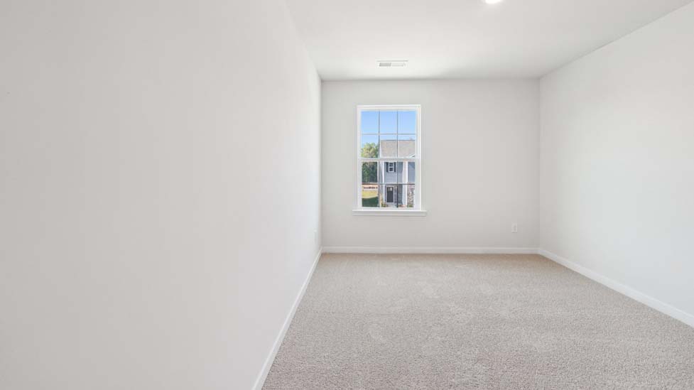 Carpeted bedroom with window