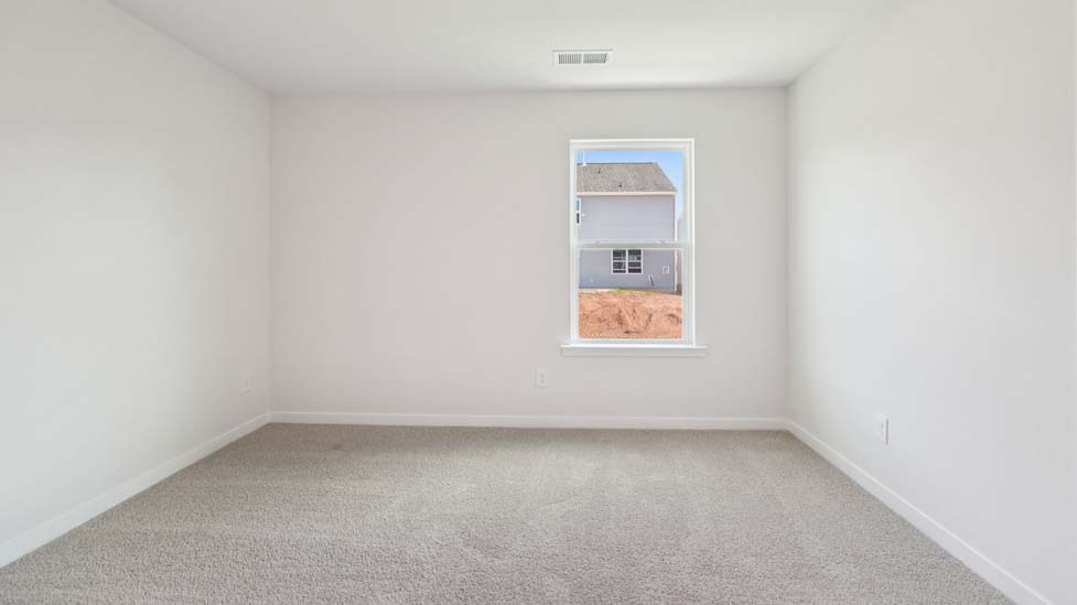 Carpeted bedroom with window