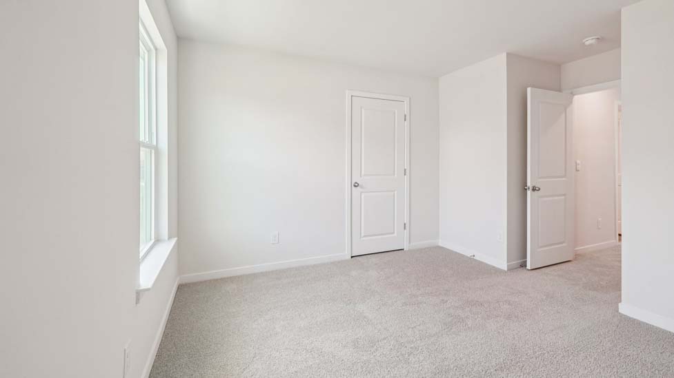 Carpeted bedroom with window
