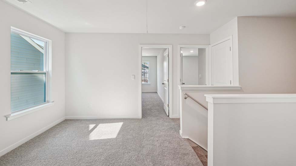 Carpeted loft space atop stairs