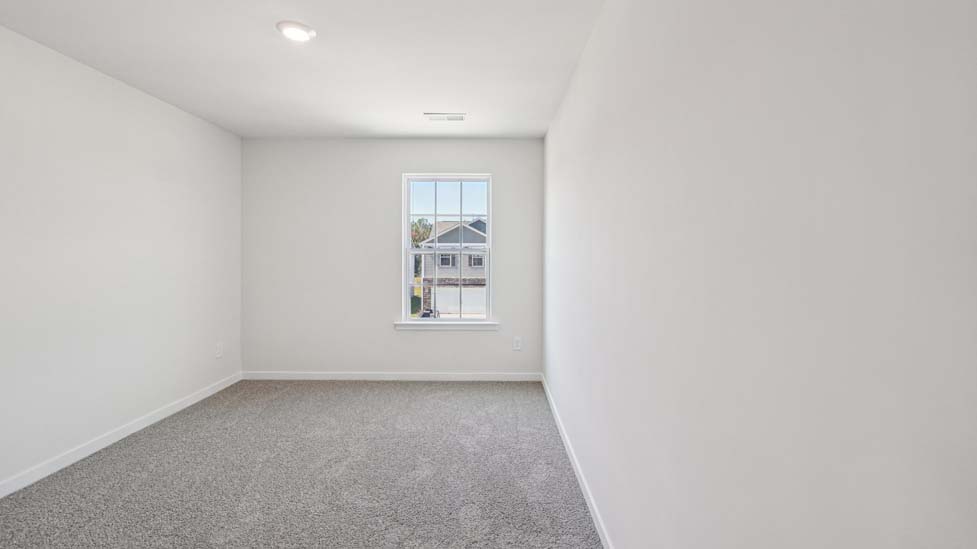 Carpeted bedroom with window